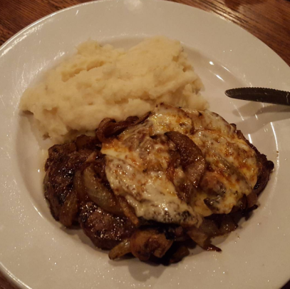 The Pub Steak, smothered with provolone, grilled onions, and mushrooms. 